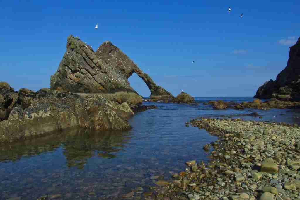 direct cremation in moray - Bow Fiddle Rock on a clear day
