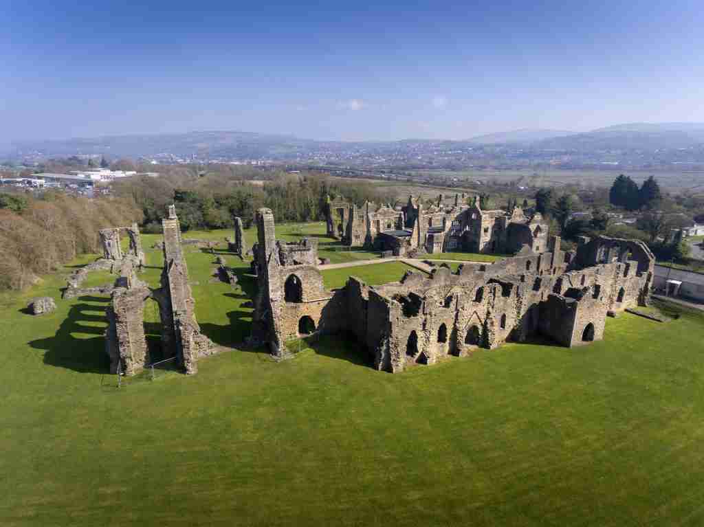 direct cremation in neath port talbot - ruins of the abbey on a ble day