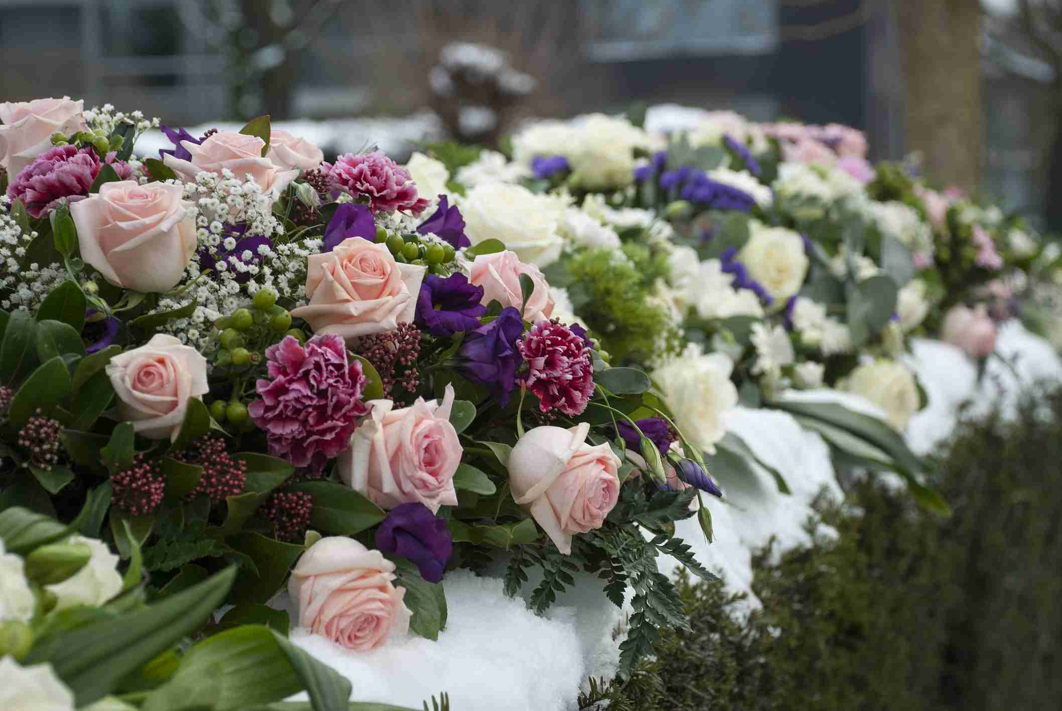 direct cremation trends UK - Funeral Flowers Arrangement In The Snow On A Cemetery