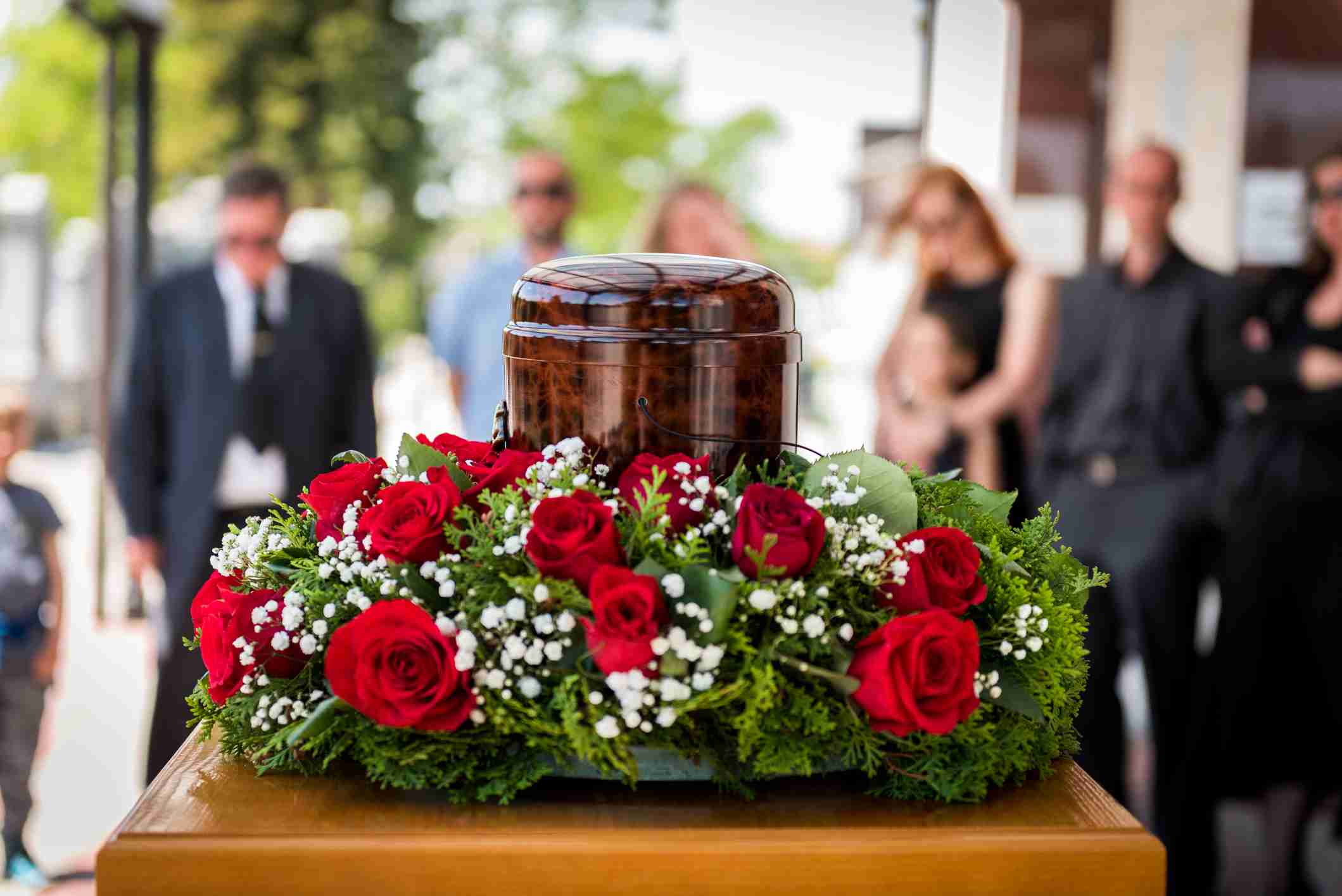 what happens to ashes after cremation - Funerary Urn With Ashes Of Dead And Flowers At Funeral