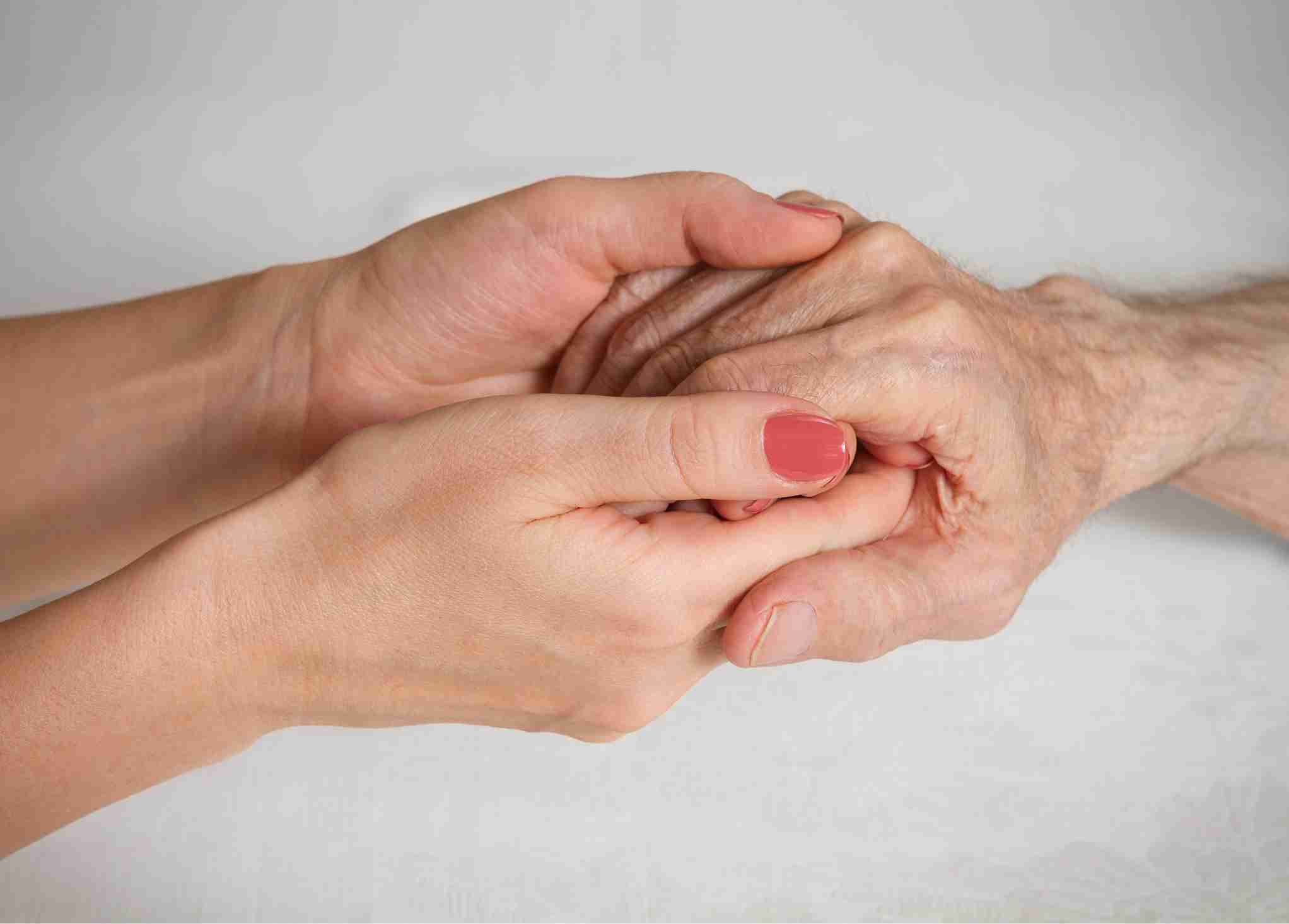 what happens when someone dies in a care home - young hands holding an elderly hand